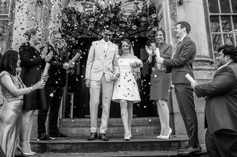 wedding couple walking down the stairs of Chelsea old town hall