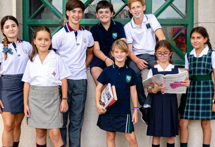 a group of young children standing in front of a building