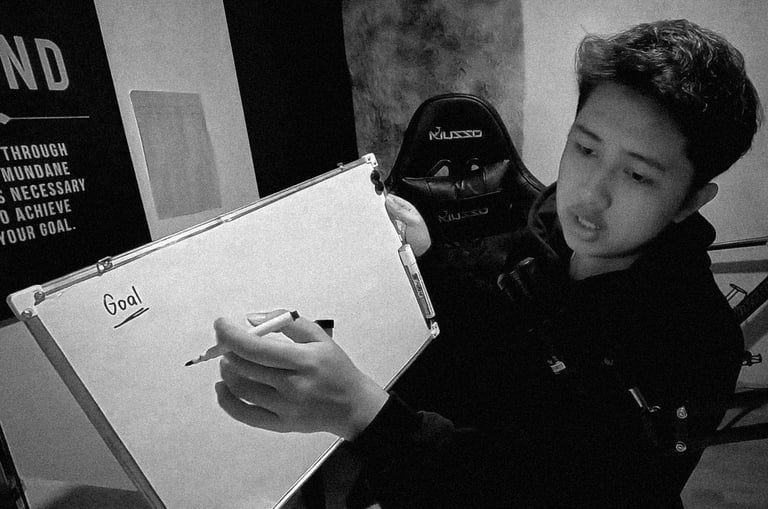 The owner of Guanzon Media writing on a white board