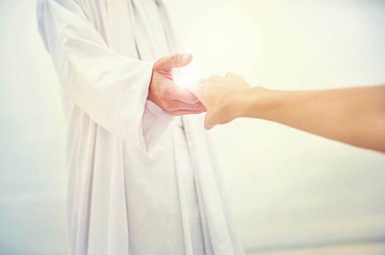 un guide spirituel habillé en blanc tend la main à une personne
