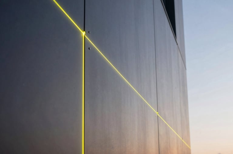 Close-up architectural shot of a premium dark ACM facade being installed, showing precise joints and neon-yellow alignment laser lines reflecting on the metallic surface, dusk lighting, structural realism.