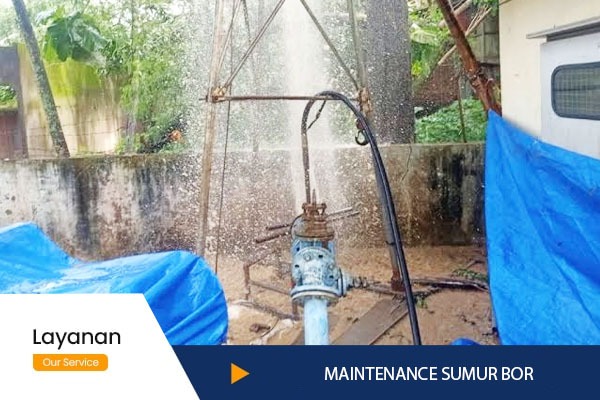 a man is spraying water from a hose in a yard