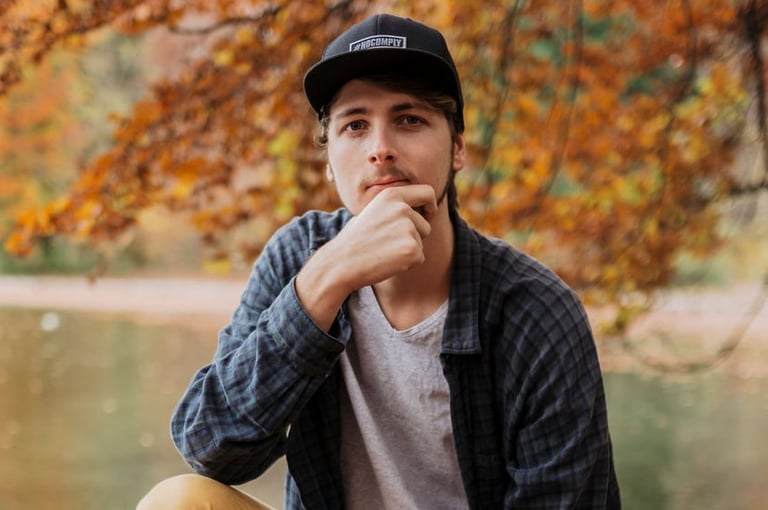 Marc Brunnert sitting on a pile of leaves