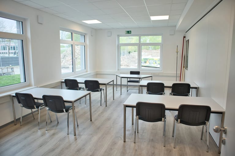 Feltec Paderborn a classroom with desks and chairs and a laptop