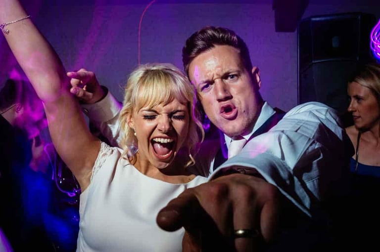 a man and woman dancing at a party