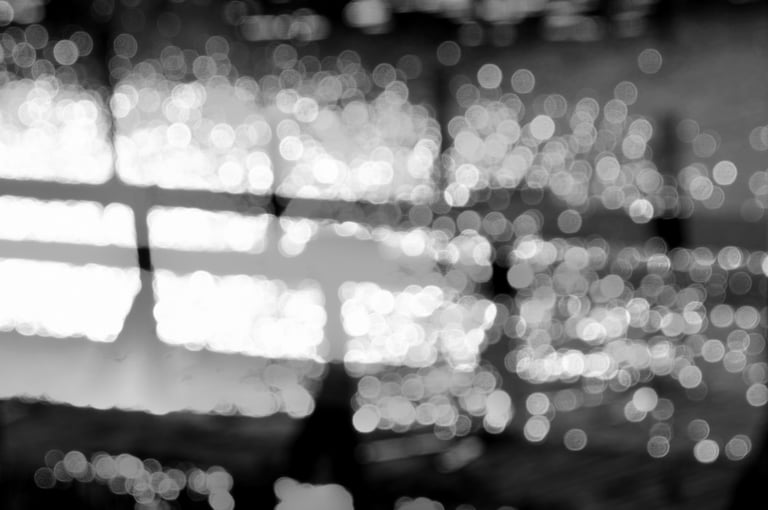 a bench on a jetty by the water and bokeh