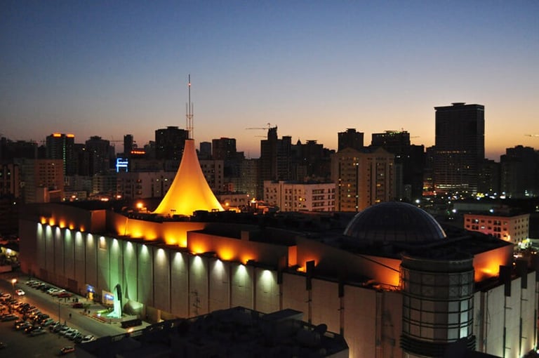 a city skyline at night time with a church and a church steeple