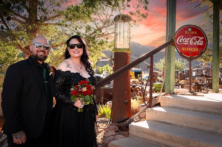 a man and woman in black dress clothes and sunglasses