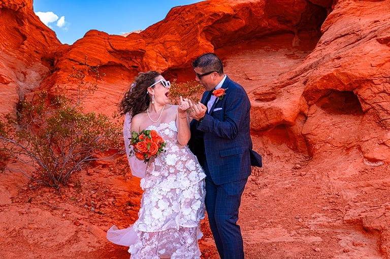 wedding couple showing wedding rings at valley of fire