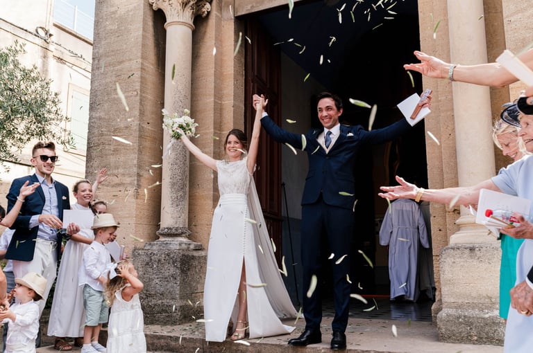a bride and groom are standing in front of a crowd of people