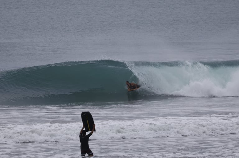 Bodyboarder riding a perfect right at a Ecuadorian Beach break