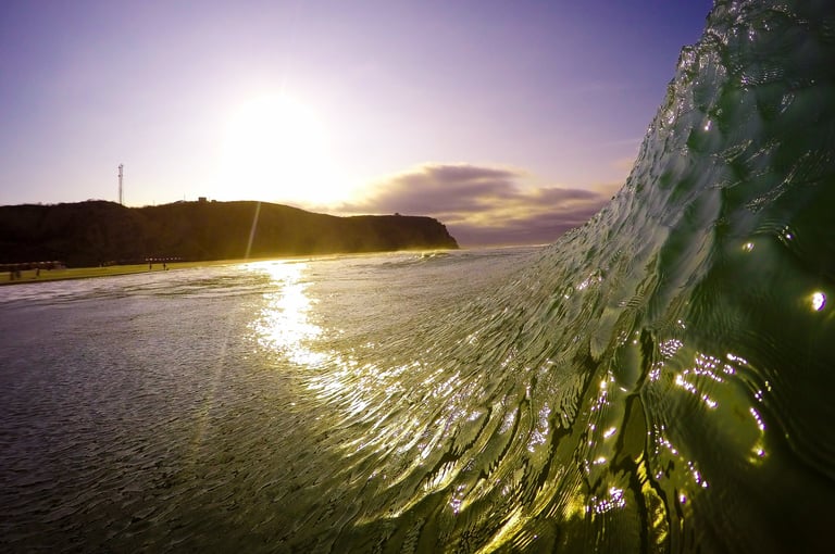Sunset view from inside a wave at a beach break in Manta city