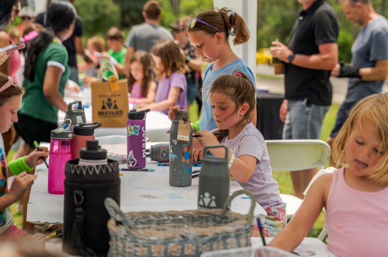 a group of children and adults sitting at a table
