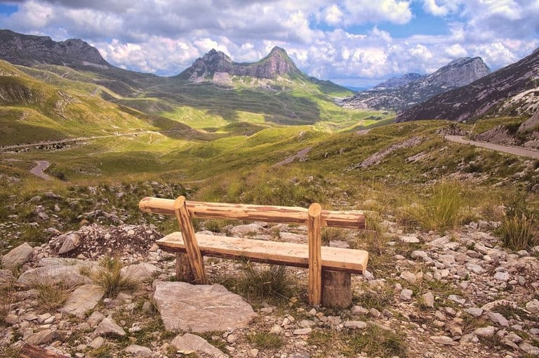 Wooden bench facing Durmitor National Park mountain peaks
