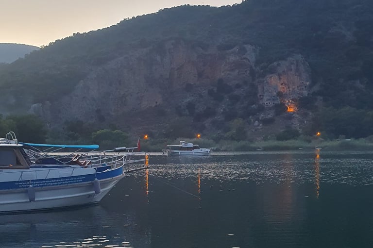 a boat is docked in a lake with a mountain in the background