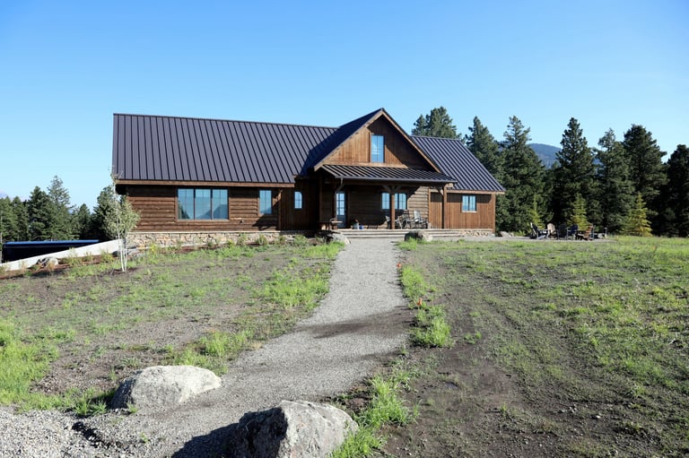 a house with a brown metal roof and a brown metal roof