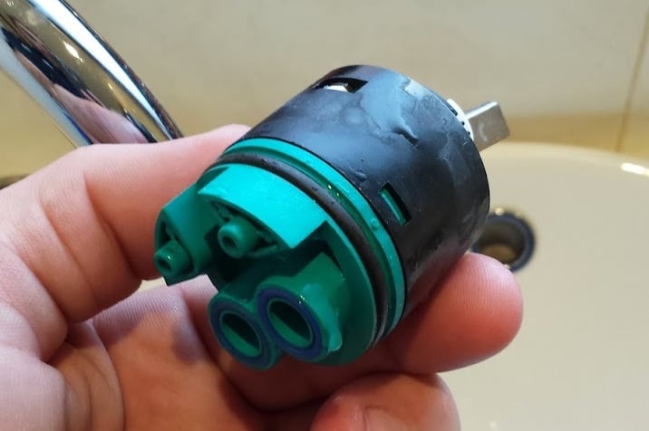 Old mixer cartridge about to be replaced