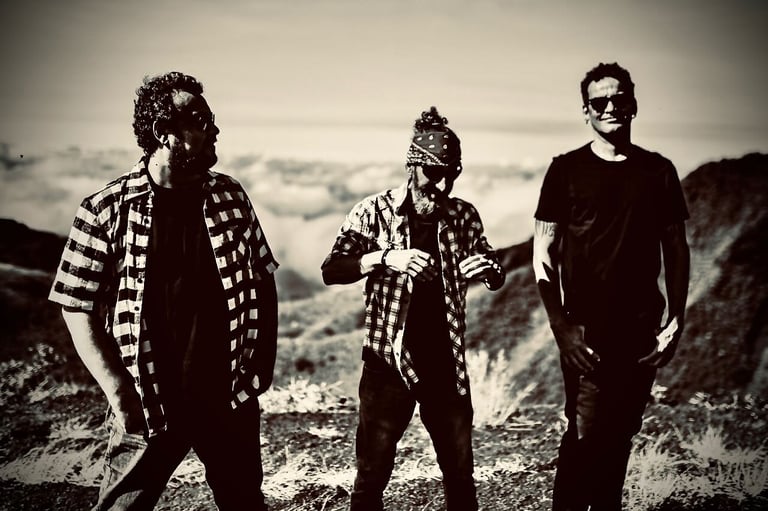 three men standing on a mountain top