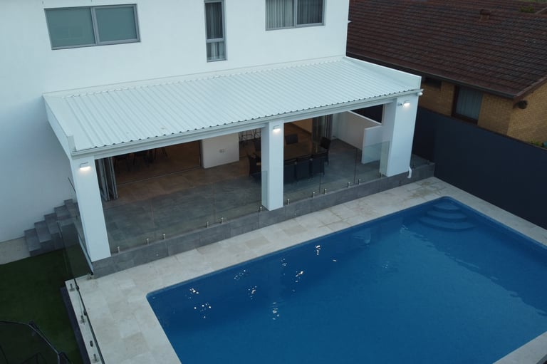 aerial shot white home with pool