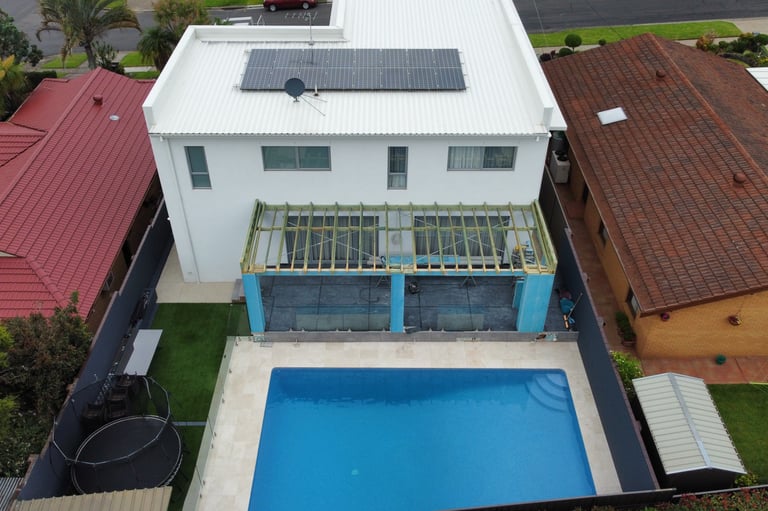aerial shot white home with pool and patio in construction