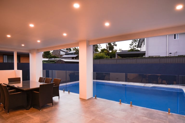 well lit tiled outdoor area with pool