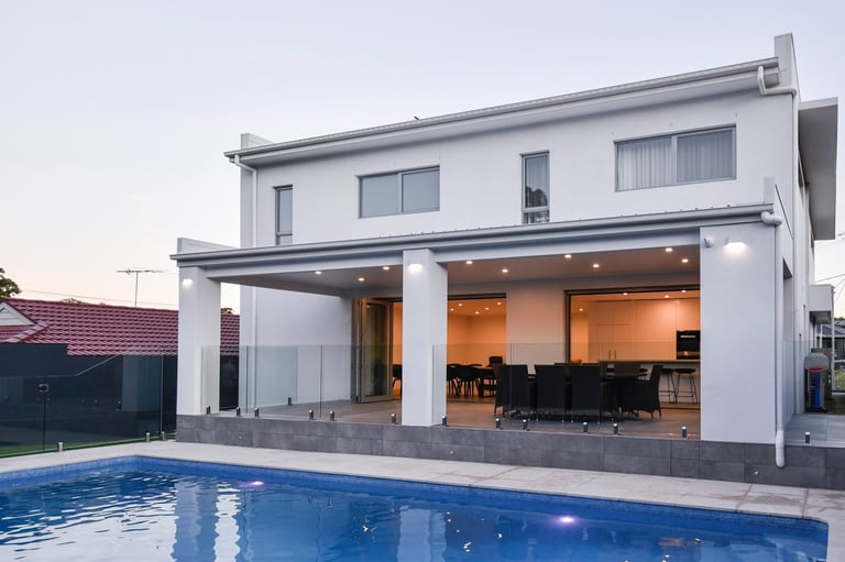 foreground pool with patio well lit outdoor entertainment