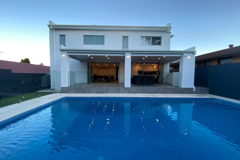 foreground pool with midground modern outdoor area