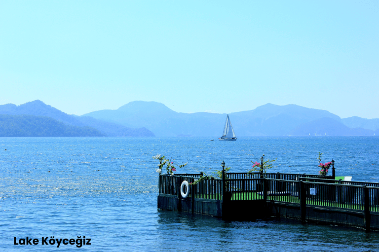 a sailboat is docked at a pier in Lake Köyceğiz, one of the best places to visit in Dalyan