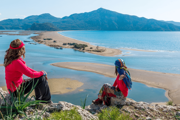 two women sitting on a rock overlooking to Iztuzu Beach
