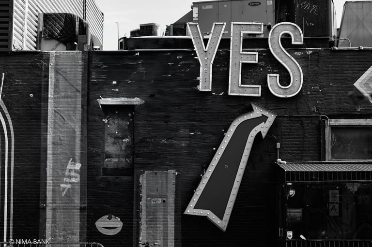black and white image of signage for a restaurant storefront with the word yes 
