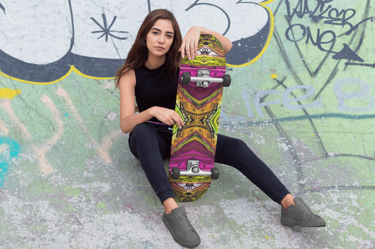 a woman sitting on a skateboard in a skateboard park