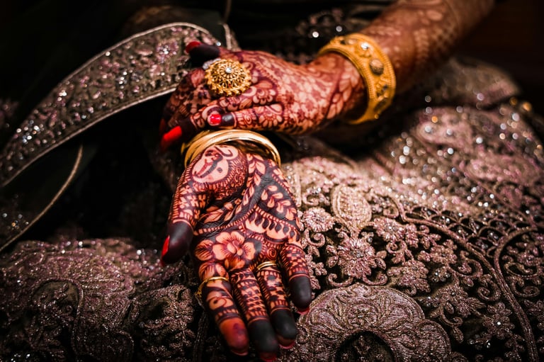 a woman's hands with hennaaches and jewelry