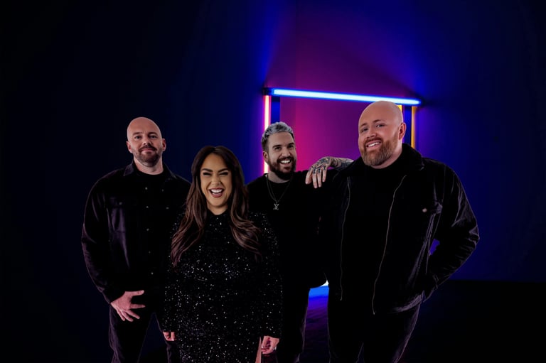 a group of people standing in front of a neon - lit room