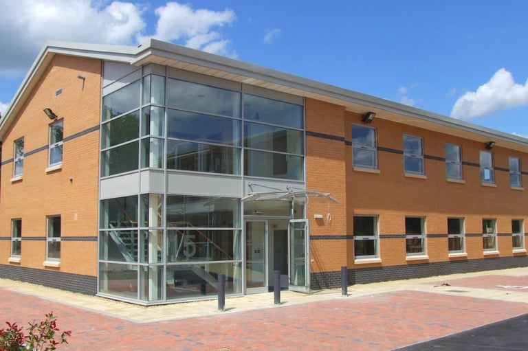 commercial building with beautiful glass entrance atrium, customer of C Thru Window Cleaning, Exeter.