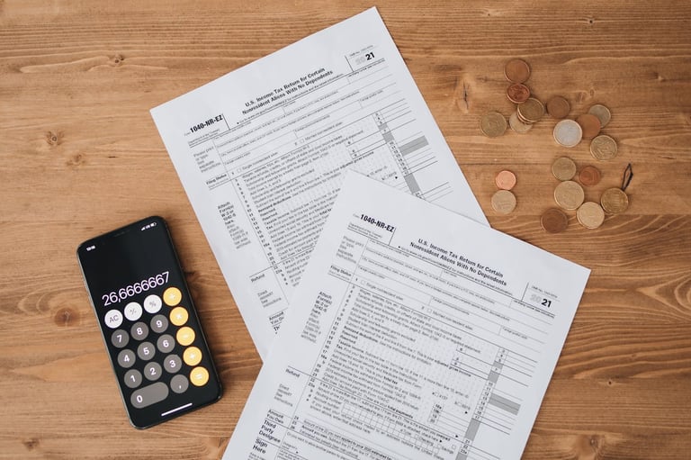calculator, money, and tax return sheet all symbolizing tax advantages gold ira can have