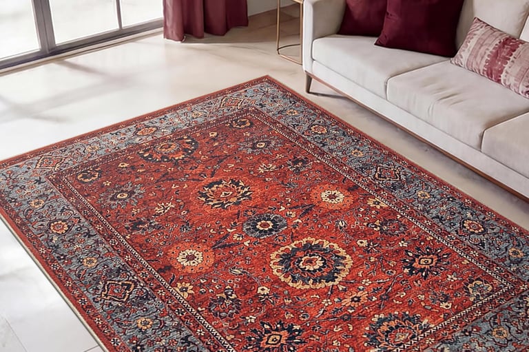 Traditional red oriental area rug with ornate floral patterns in a modern living room setting.