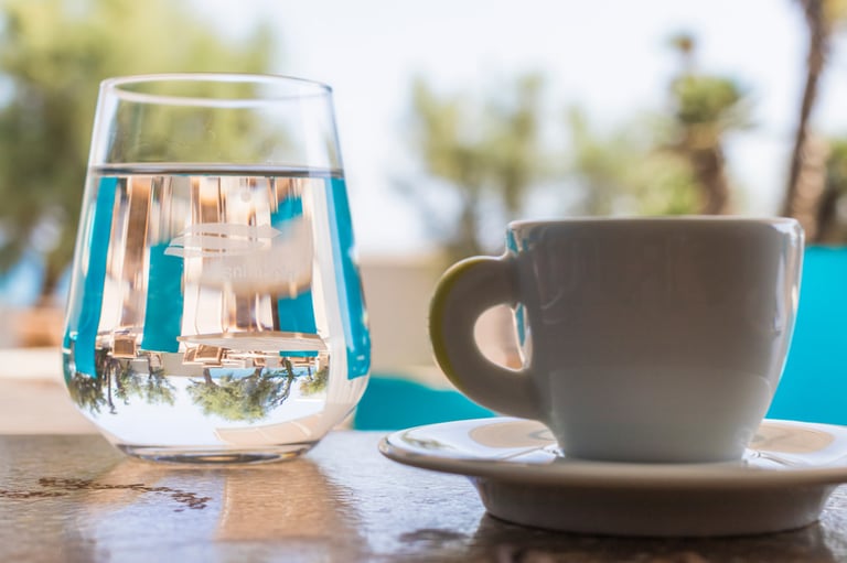 a cup of water and a glass of water