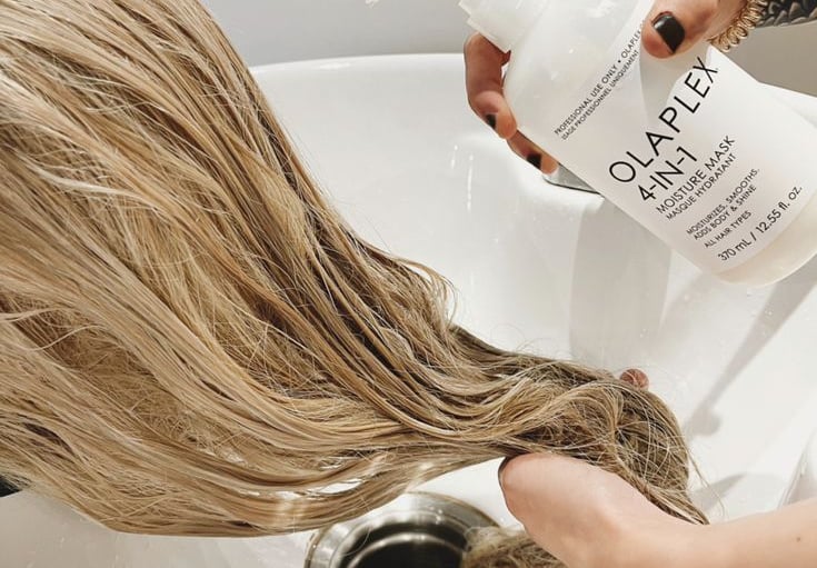 Hair model applying Olaplex during color treatment.