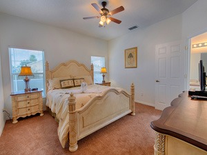 a Master bedroom with a bed and a ceiling fan
