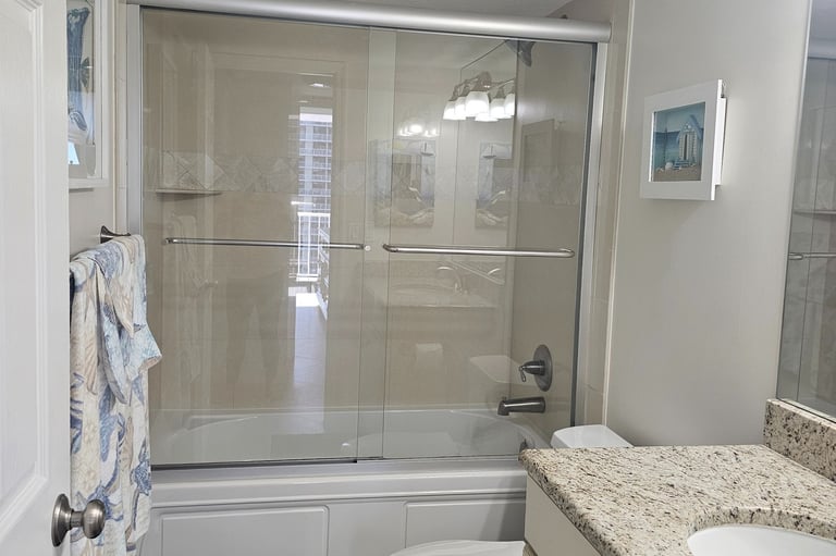 a bathroom with a shower and tub
