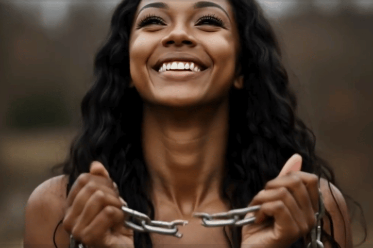A female holing broken chains and smiling