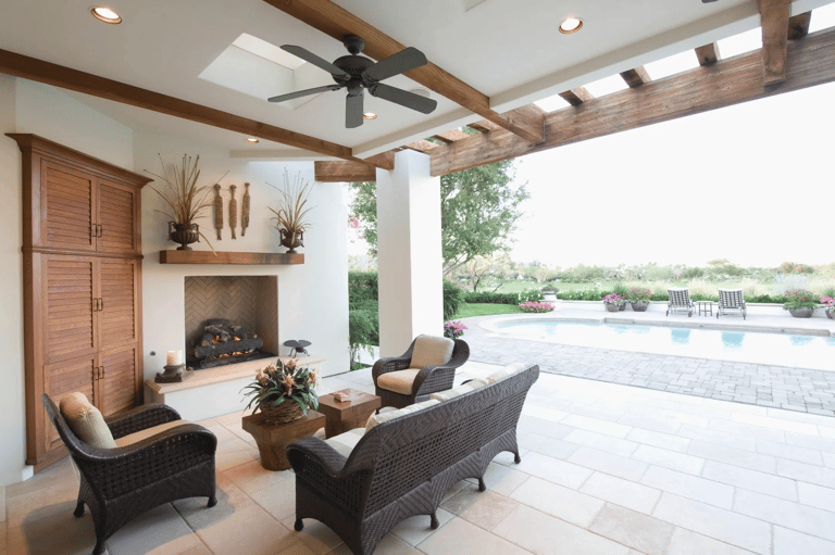a patio with wicker furniture and a fireplace