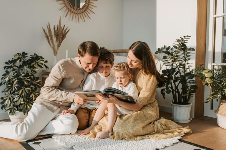 a family of two children sitting on a rug