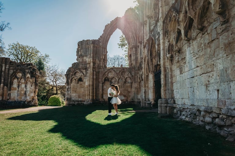 Bride standing near historic stone ruins in York, photographed by Fred Art Studio.