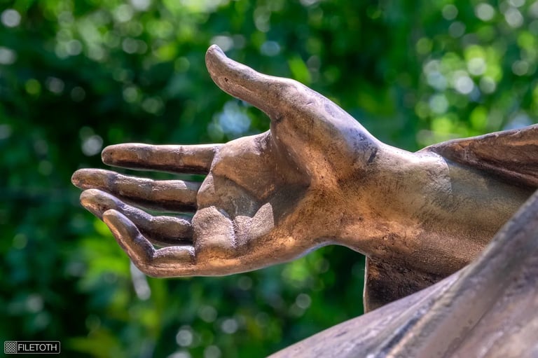 Close-up of the protective hand of Saint Barbara, showing sculpted details and gentle gesture.