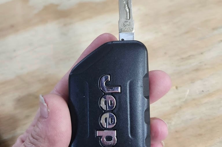 Holding jeep key fob representing auto locksmith services in Boone.
