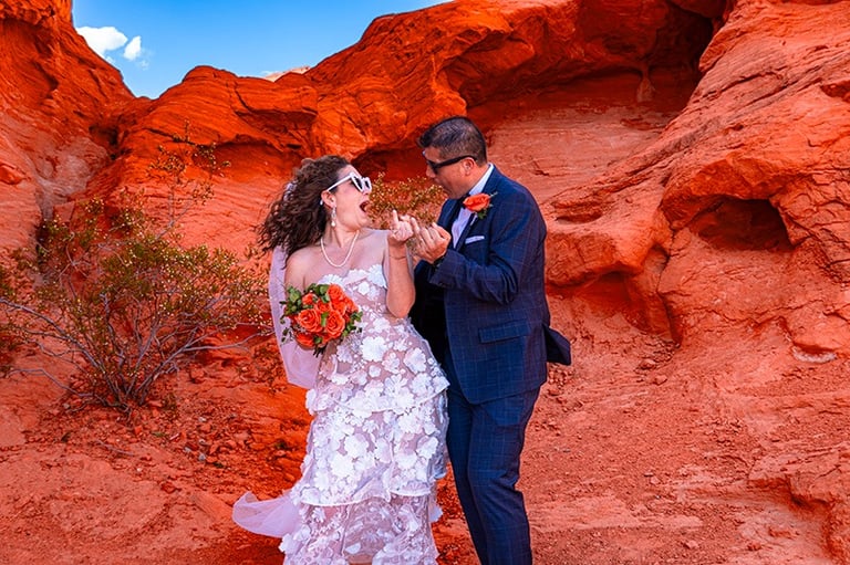 wedding couple showing wedding rings at valley of fire