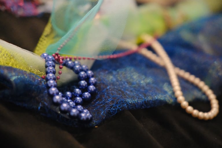 various sizes of pearls on net like fabric and mesh meant to be played with as tactile elements 