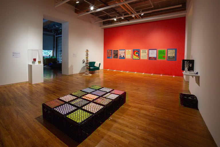 Exhibition wide angle view of different sensory objects including milk crates and touchable posters.