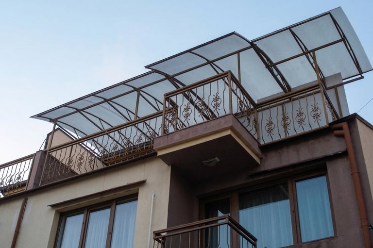 Modern rooftop terrace with wrought iron railings and a durable polycarbonate canopy for sun protection.